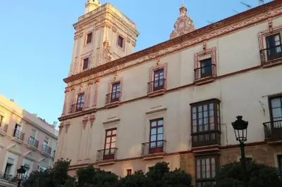 a building with a clock tower on top of it at Las 4 Torres by Gades Gestión in Cádiz