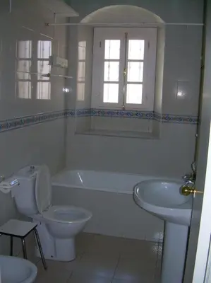 a bathroom with a toilet and a tub and a sink at Las 4 Torres by Gades Gestión in Cádiz