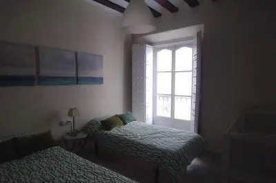 a bedroom with two beds and a window at Las 4 Torres by Gades Gestión in Cádiz