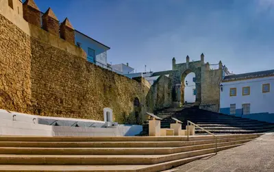 a set of stairs next to a brick wall at Casita de la Suerte in Medina Sidonia