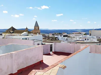 a view of a city from the roof of a building at Casita de la Suerte in Medina Sidonia