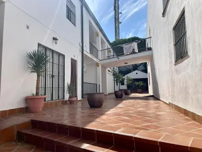 a courtyard of a building with potted plants at Pescadores del Sur in Chiclana de la Frontera
