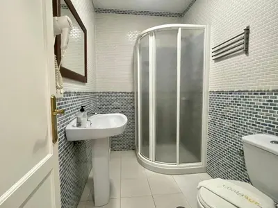 a bathroom with a shower and a sink and a toilet at Pescadores del Sur in Chiclana de la Frontera