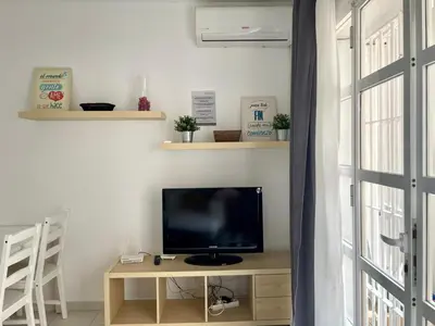 a television sitting on a table in a living room at Pescadores del Sur in Chiclana de la Frontera