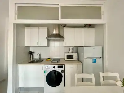 a kitchen with a white refrigerator and a dishwasher at Pescadores del Sur in Chiclana de la Frontera