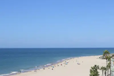 a group of people on a beach with the ocean at Summerlandrota Cordoba8 in Rota