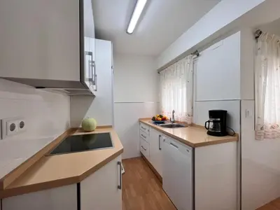 a kitchen with white cabinets and a counter top at Summerlandrota Cordoba8 in Rota