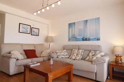 a living room with a couch and a table at Summerlandrota Cordoba8 in Rota