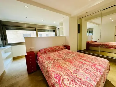 a bedroom with a large bed and a large mirror at Amanecer frente al Mar Grupo AC Gestion in Cádiz