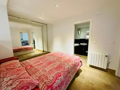 a bedroom with a large bed and a mirror at Amanecer frente al Mar Grupo AC Gestion in Cádiz