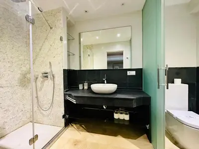 a bathroom with a sink and a toilet and a mirror at Amanecer frente al Mar Grupo AC Gestion in Cádiz