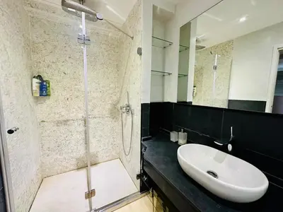 a bathroom with a sink and a shower at Amanecer frente al Mar Grupo AC Gestion in Cádiz