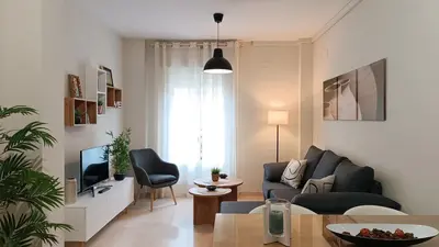 a living room with a couch and a tv at Sherryflat Aina Parking in Jerez de la Frontera