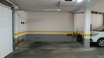 a garage with a car parked in it at Sherryflat Aina Parking in Jerez de la Frontera