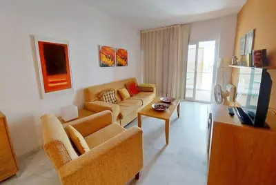 a living room with a couch and a tv at Piso a dos calles de la playa in El Puerto de Santa María