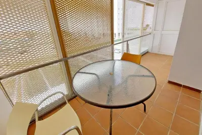 a bedroom with a orange bed with a red pillow at Piso a dos calles de la playa in El Puerto de Santa María