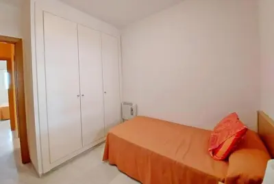 a white bathroom with a sink and a toilet at Piso a dos calles de la playa in El Puerto de Santa María