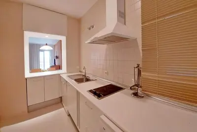 a kitchen with a dining room table and chairs at Piso a dos calles de la playa in El Puerto de Santa María
