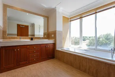 a bathroom with a tub and a large window at Arcos Gardens Sol Rent Golf in Arcos de la Frontera