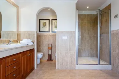 a bathroom with a shower and a sink and a toilet at Arcos Gardens Sol Rent Golf in Arcos de la Frontera