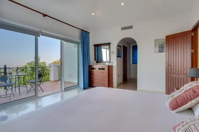 a bedroom with a bed and a balcony at Arcos Gardens Sol Rent Golf in Arcos de la Frontera