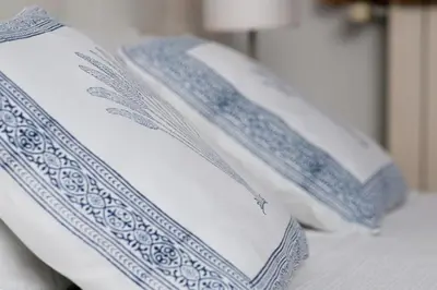 two blue and white pillows on a bed at Casa Limon in Sanlúcar de Barrameda