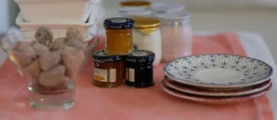 a table topped with jars and a bowl of food at Casa Limon in Sanlúcar de Barrameda