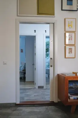 a sliding door leading into a room with a table at Casa Limon in Sanlúcar de Barrameda