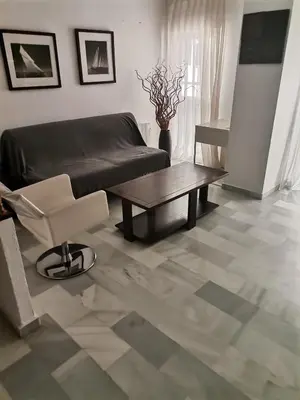 a living room with a couch and a coffee table at Duplex con garaje privado in Cádiz