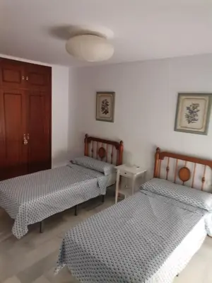 a room with two beds and a door at Duplex con garaje privado in Cádiz