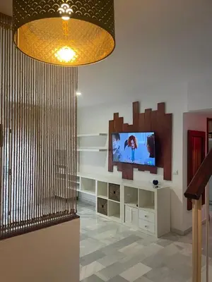 a living room with a flat screen tv on a wall at Duplex con garaje privado in Cádiz