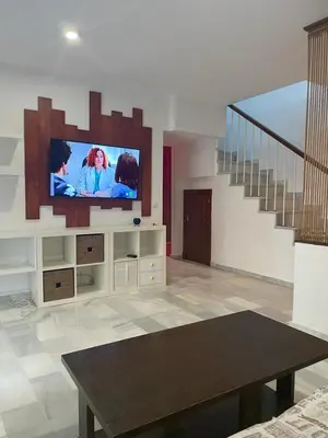 a living room with a flat screen tv on the wall at Duplex con garaje privado in Cádiz