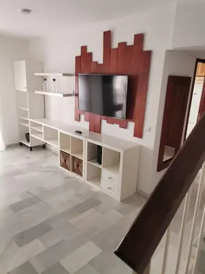 a living room with a tv on a wall at Duplex con garaje privado in Cádiz