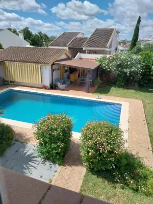 a swimming pool in front of a house at Casa Victoria in Arcos de la Frontera