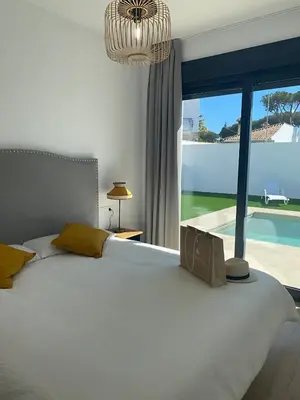 a bedroom with a large bed and a large window at Villa Tres Mares in Novo Sancti Petri