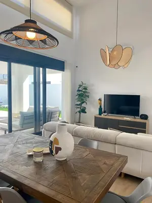 a living room with a table and a couch at Villa Tres Mares in Novo Sancti Petri