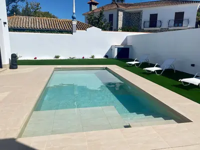 a swimming pool in the backyard of a house at Villa Tres Mares in Novo Sancti Petri