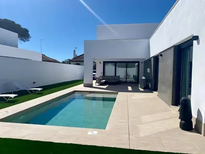 a swimming pool in the backyard of a house at Villa Tres Mares in Novo Sancti Petri