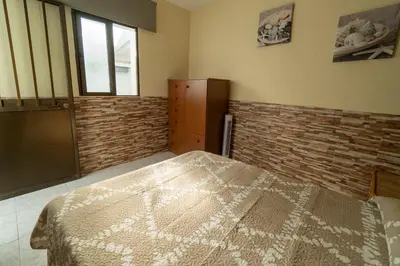 a bedroom with a bed and a brick wall at Casa rural El Tejar de Algar / 1262 in Algar