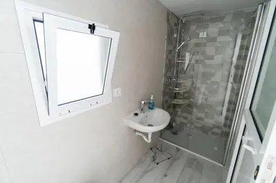a bathroom with a sink and a shower and a window at Casa rural El Tejar de Algar / 1262 in Algar