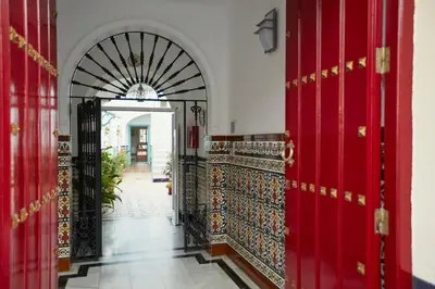 an entrance to a building with red doors at Hostal Campo Nuevo in Sanlúcar de Barrameda