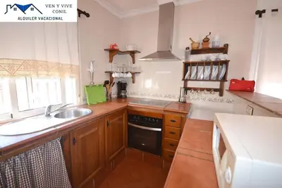 a kitchen with a sink and a stove at Chalet con Piscina privada en Conil in Conil de la Frontera