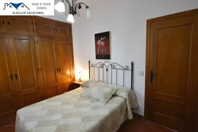 a bedroom with a bed with a blanket on it at Chalet con Piscina privada en Conil in Conil de la Frontera