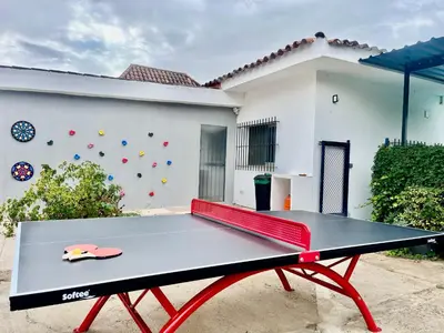 a ping pong table in front of a house at Villa San Patricio I Piscina Privada I Jacuzzi Spa I BBQ I PS5 I Aire Acon I 3000m2 I 5min-Centro in Jerez de la Frontera