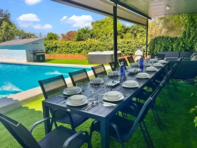 a long blue table with plates and glasses on it next to a pool at Villa San Patricio I Piscina Privada I Jacuzzi Spa I BBQ I PS5 I Aire Acon I 3000m2 I 5min-Centro in Jerez de la Frontera