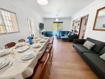a dining room with a long table and a couch at Villa San Patricio I Piscina Privada I Jacuzzi Spa I BBQ I PS5 I Aire Acon I 3000m2 I 5min-Centro in Jerez de la Frontera