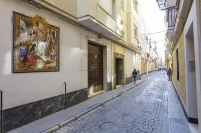 an empty street with a painting on the side of a building at Apartamento con patio en Cádiz centro in Cádiz
