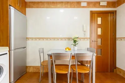 a kitchen with a white table and chairs at Apartamento con patio en Cádiz centro in Cádiz