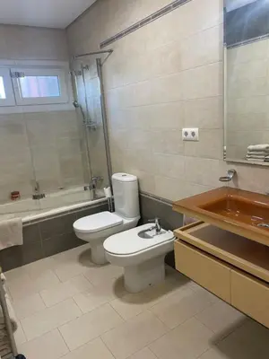 a bathroom with a toilet and a tub and a sink at Villa Sagrario in Chiclana de la Frontera