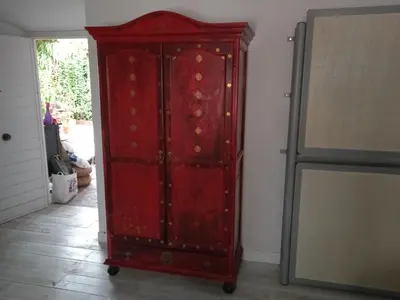 a red cabinet is sitting in a room at La gota de leche 3 in Sanlúcar de Barrameda